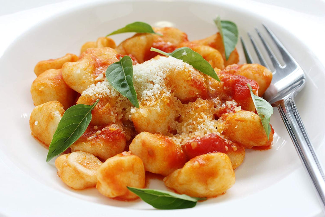 fresh gnocchi in a bowl with a light red sauce