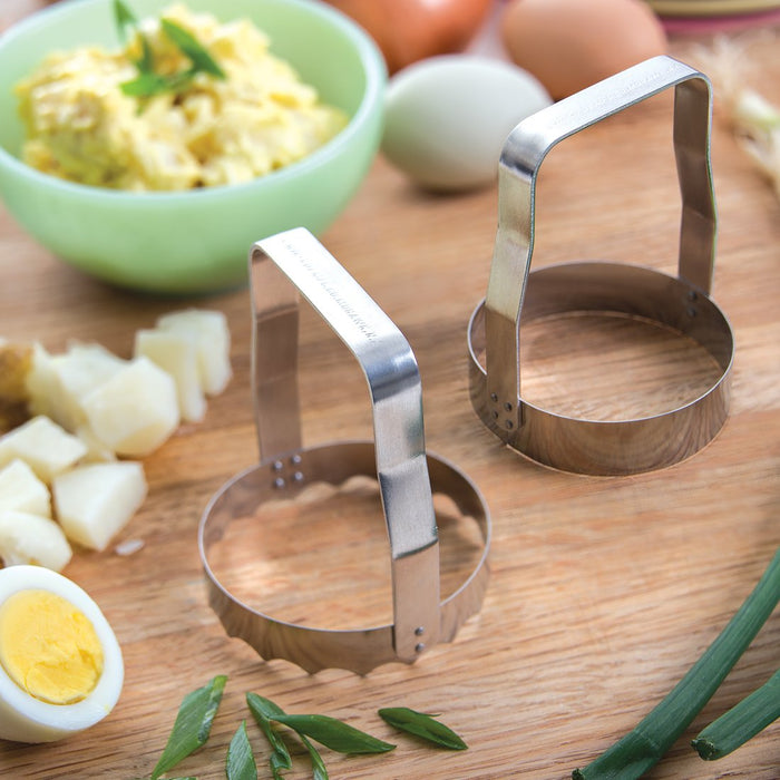manual food choppers with chopped eggs on a cutting board serrated and plain edge