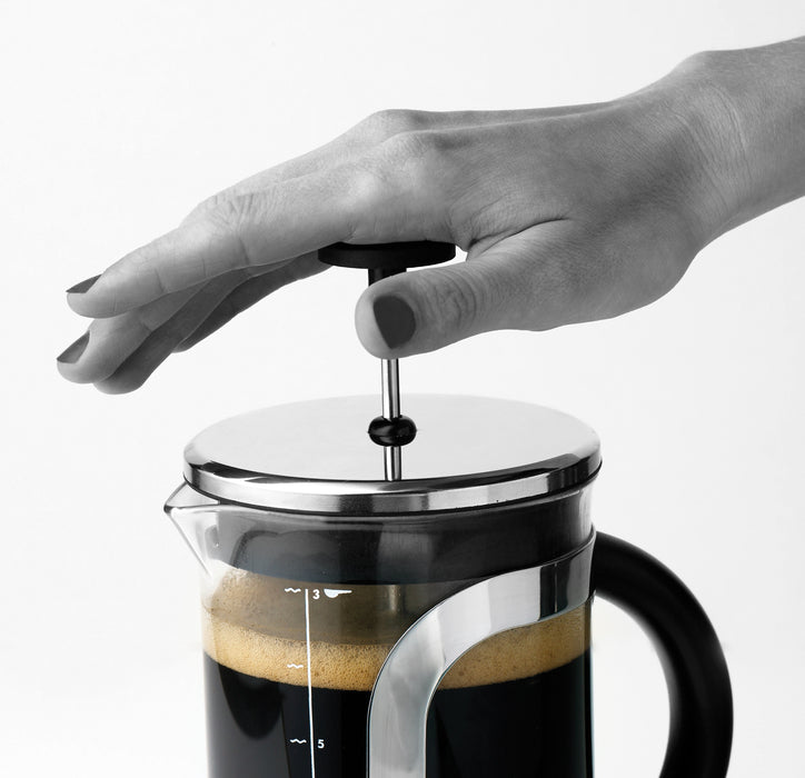aerolatte french press coffee maker plunger being pushed down